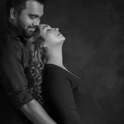 Stripped of color, the focus shifts to pure emotion. This black and white portrait captures the deep connection and peaceful love between the expecting couple.