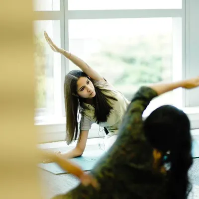 Here I am guiding a student through Trikonasana, or Triangle Pose, during a corporate wellness session. I focus on proper alignment to ensure you get the full benefits of each posture safely. These classes are a great way to build strength and flexibility.