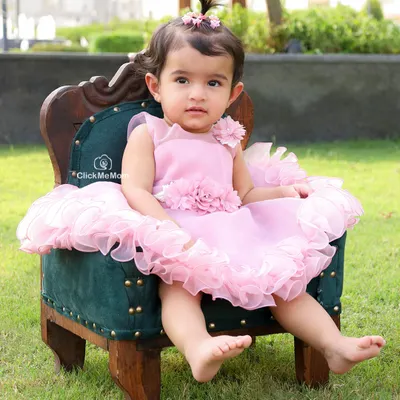 A little princess on her throne in the garden. The lush green grass and soft natural light create a beautiful, serene setting for this outdoor portrait.