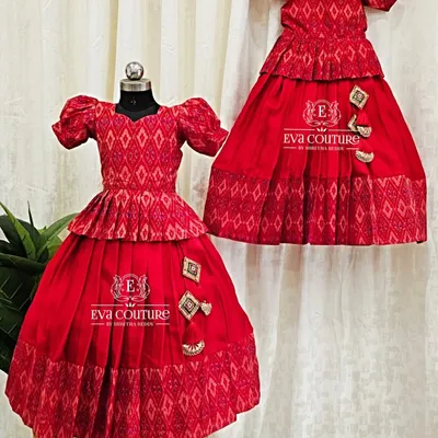 A perfect example of a sibling twinning set. These two red Ikat lehengas are made in different sizes for sisters.