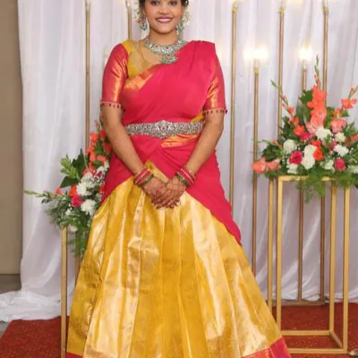 A happy client in her custom-designed Langa Davani for her big day. The vibrant combination of a yellow skirt and a pink blouse with a matching davani creates a classic and joyful look.