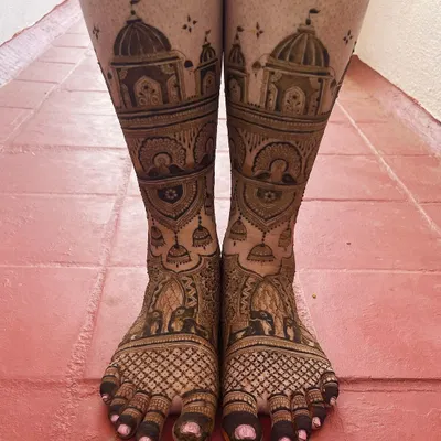 A grand and intricate design for bridal feet, featuring palace architecture, elephants, and hanging temple bells. This is perfect for the bride who wants a truly royal look.