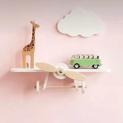 Let their imagination take flight with this airplane-themed nursery shelf. It’s crafted from solid wood with a spinning propeller, making it a delightful and sturdy spot for displaying small toys and decor.