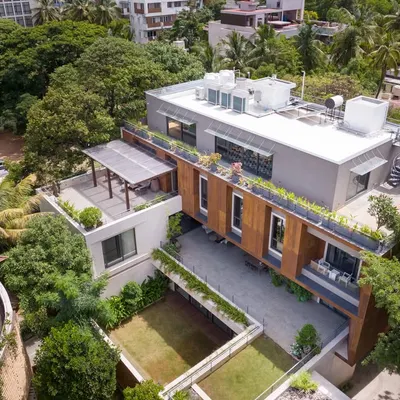 An aerial view of The U-L-I Residence, a 25,000 sq. ft. home designed for a multigenerational family. The architecture organizes shared public spaces on the ground floor and private family units above, all connected by a series of courtyards and green spaces.