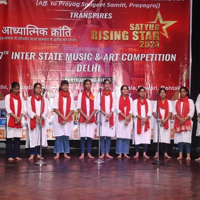 A group of our vocal students lined up on stage, ready to perform a choral piece at the "Satyug Rising Stars" competition. This is where practice turns into a confident performance.
