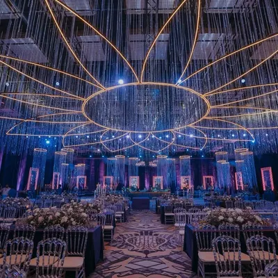Step into a world of shimmer and song. For this Sangeet, I designed a magnificent ceiling installation where strings of crystals radiate from a central point, creating a massive floral-inspired canopy of light that set the stage for an unforgettable celebration.