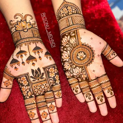 This design is a beautiful symphony of traditional Indian motifs. It features jhumka earrings, lotus flowers, and a central mandala, creating a different yet complementary look on each hand.