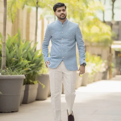 A classic full-length portrait of the groom. His confident walk and stylish ethnic wear are perfectly captured in this bright, outdoor shot.