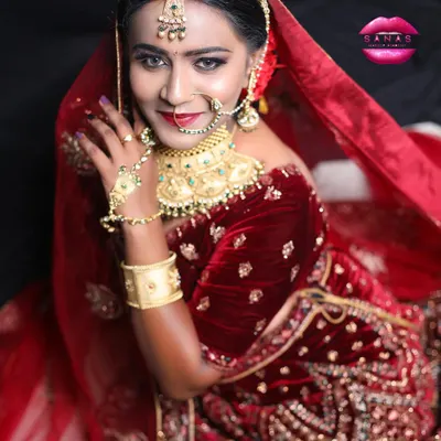A stunning royal bridal look created for a portfolio shoot. This image showcases a complete look with velvet lehenga, heavy jewelry, and dramatic eye makeup.