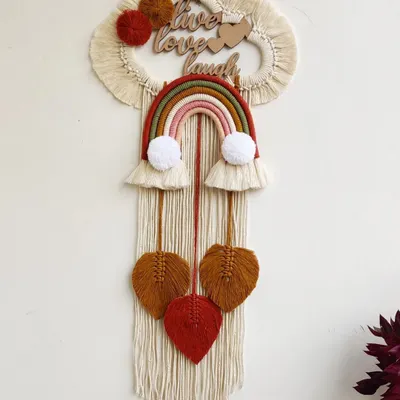 This large, personalized wall hanging was created for a couple with the motto "Live, Love, Laugh." It combines a rainbow, hearts, and custom lettering for a truly meaningful piece.