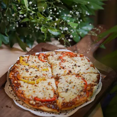 A classic cheese and veggie pizza, fresh from the oven. My live pizza station is a huge hit at kids' parties, where they can see their favorite food being made.