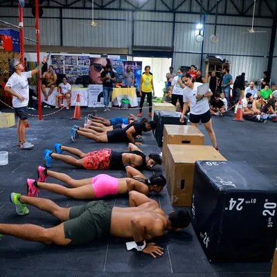 The competition floor during The Bengaluru Throwdown. Athletes line up for synchronized push-ups, a test of teamwork and pacing under pressure.