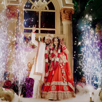 The Varmala ceremony is a highlight of any wedding, and I love capturing it with all the grandeur it deserves. The sparklers and smoke create a magical, celebratory atmosphere for the couple's big moment.