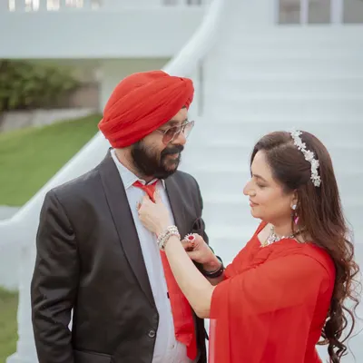 A sweet, candid moment during an anniversary shoot. The bride adjusts her husband's tie, a small gesture of love and care that I love to capture.