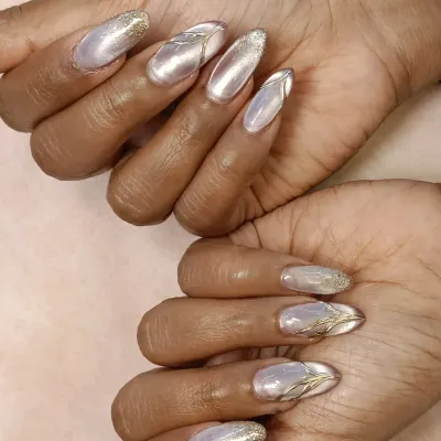 I combined three popular effects in this one set: a pearlescent cat-eye base, a touch of gold chrome for linework, and a sprinkle of fine glitter on the tips. This is a perfect example of a custom gel extension set.