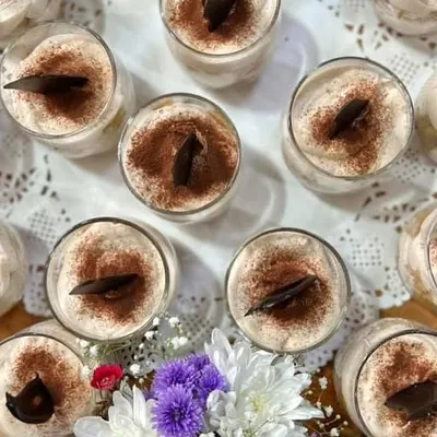 A tray of my sophisticated Tiramisu cups. This classic Italian dessert, with its layers of coffee-soaked ladyfingers and creamy mascarpone, is always an elegant choice for any occasion.