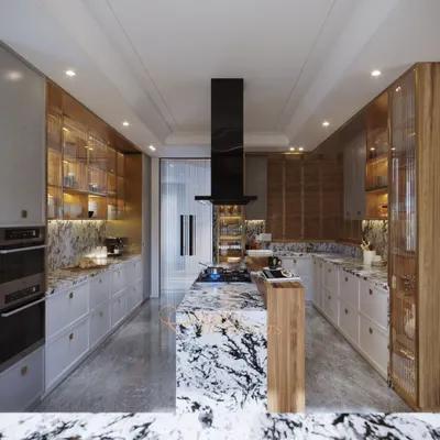 This gourmet kitchen combines bold design with practical function. The dramatic marble island serves as the centerpiece, complemented by custom cabinetry with integrated lighting and a layout planned for an intuitive culinary workflow.