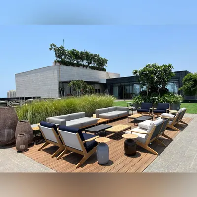 This rooftop lounge in Mumbai was designed for entertaining. We used a combination of wooden decking, modern outdoor sofas, and strategically placed planters to create a spacious and elegant setting with panoramic views.