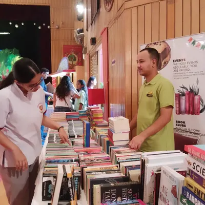 Our team member helps a student browse through our collection at the Springdales school book fair. We enjoy interacting with students and helping them find their next favorite book.