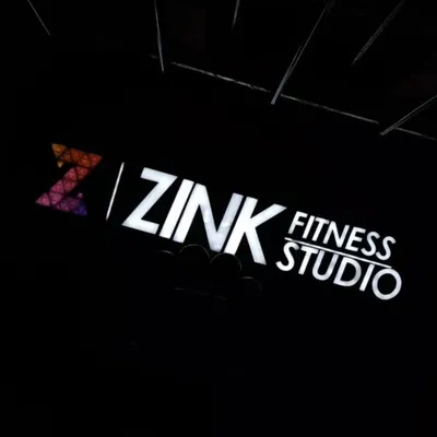 The Zink Fitness Studio sign lit up at night. This is your beacon for a healthier, stronger, and happier life.