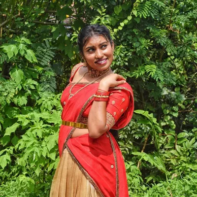 A happy client celebrating her housewarming in a traditional red and gold half-saree. This is exactly why I started this rental service, to be a part of your joyful moments without the stress of buying.