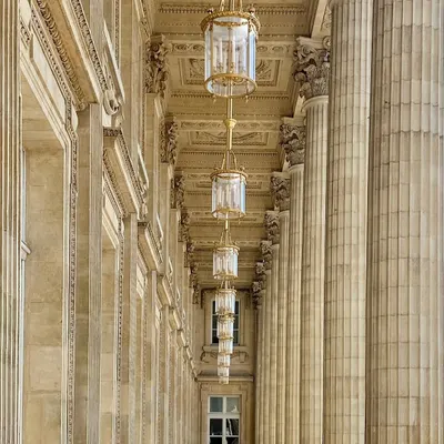 Walking through Paris, I am always captivated by the perfect symmetry and grandeur of its architecture. This colonnade, with its repeating columns and magnificent chandeliers, is a beautiful example of timeless design. These are the moments that fuel my creativity long after I've returned home.