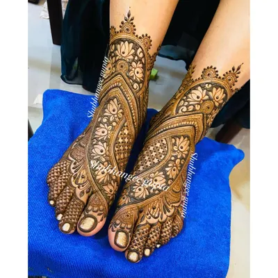 A full-coverage bridal foot design with intricate floral and paisley patterns. The design flows beautifully from the toes up to the ankle, creating an elegant and complete bridal look.