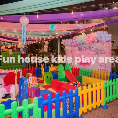Our full-scale Rainbow Kids Play Area, featuring a multi-colored soft play structure with slides, climbers, a ball pit, and rockers, all safely enclosed.