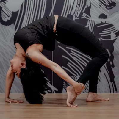Urdhva Dhanurasana, or Wheel Pose, is a powerful heart opener that increases flexibility in the spine. This asana strengthens the entire body and is known to create a feeling of exhilaration and joy.