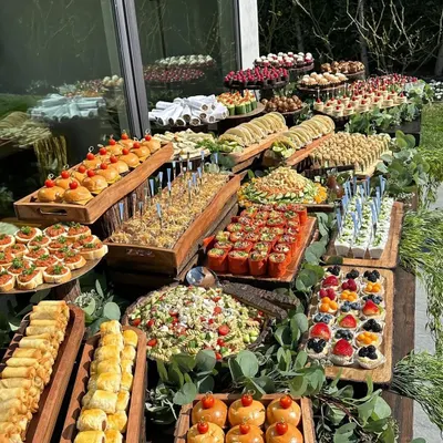 A stunning example of the catering spreads we can arrange. This rustic, abundant table features a wide variety of appetizers, salads, and finger foods, perfect for a welcome dinner or cocktail hour.