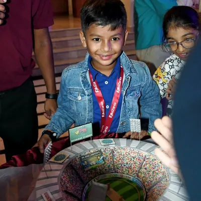 The birthday boy, Prishiv, beaming with joy in front of his incredible cricket stadium cake. Seeing smiles like this is why I love my job.