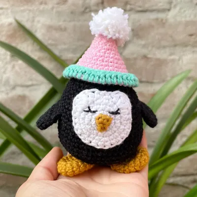 Meet Zippy the penguin. This little amigurumi character is made with soft cotton yarn and has a sweet, sleepy expression. I love how the little pom-pom party hat gives him such a fun personality.