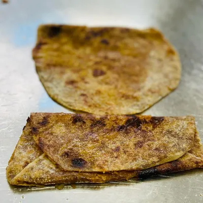 This is the classic bele holige, a sweet flatbread that is a centerpiece of Karnataka celebrations. I prepare it fresh to ensure that authentic, homemade taste.