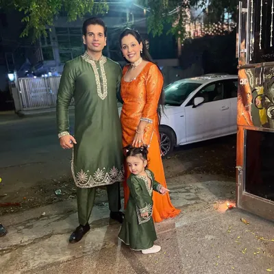 A complete family look for a festive celebration. We coordinated the father and daughter in matching green Mul Mul kurta sets with leather embroidery, while the mother shines in a complementary orange outfit.
