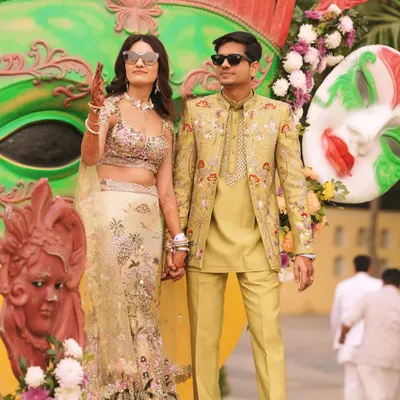 The happy couple at their vibrant Mehendi ceremony. My client's custom lime-green, embroidered bandhgala set perfectly complements the festive decor and his bride's stunning lehenga.