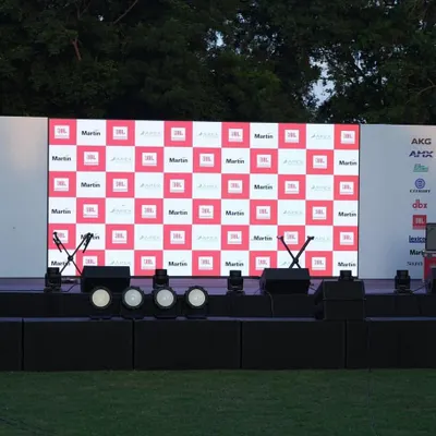 The complete stage setup for the 'Sound That Matters' corporate event in Delhi, ready for the show. This includes a custom-branded LED backdrop, stage monitors, and a full lighting rig.