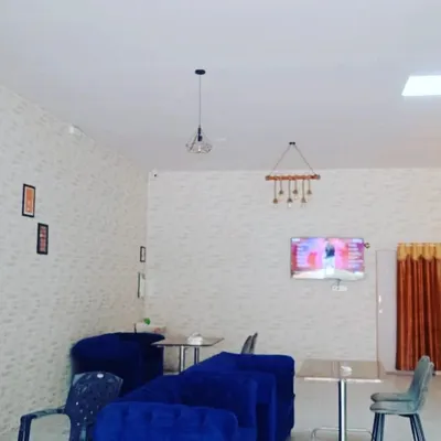 This image shows a simple yet effective curtain installation in a commercial lounge or cafe setting. The solid color curtain provides privacy and light control for the window area, complementing the modern, minimalist decor of the space. This demonstrates my ability to handle projects beyond residential homes.
