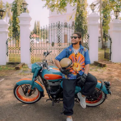 Here I am with the new Royal Enfield Goan Classic 350. This shot was designed to highlight the bike's classic charm against a backdrop of Goan architecture, creating a vibrant, aspirational lifestyle image.