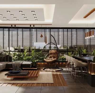 A complete view of a terrace sunroom project, integrating a lounge area, dining space, and kitchen. We used long planters filled with tall faux grasses to create a green border and enhance the connection to the outdoors.