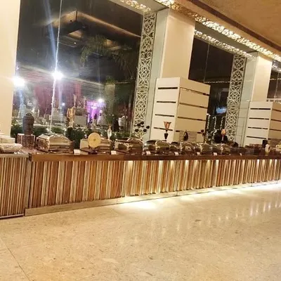A wide view of a sleek, modern buffet counter designed for a large corporate conference. The clean lines and integrated lighting create a sophisticated and professional look.