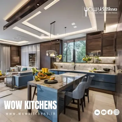 This is where luxury meets functionality. An expansive open-plan kitchen featuring a blue island with a marble waterfall countertop, seamlessly integrating with the living area for the ultimate entertainment space.