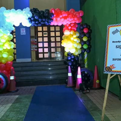 Ready, Set, Go! The entrance to a Ferrari-themed 5th birthday party, complete with a balloon arch, traffic cones, and a welcome sign to get the little racers excited.