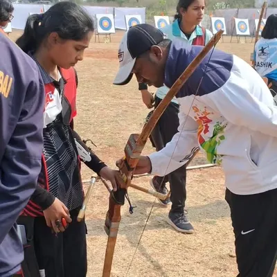 Proper technique starts from day one. I provide personalized instruction, like adjusting a student's grip on this Indian round bow, to ensure a safe and effective learning experience during our beginner archery lessons.