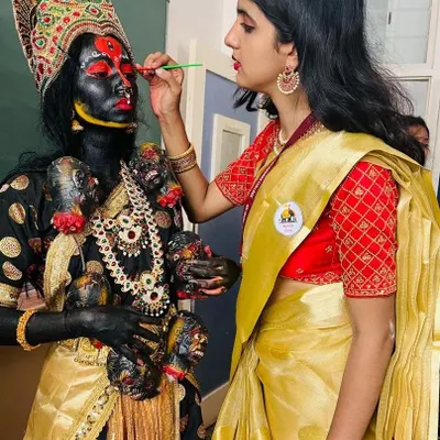 Here I am applying the intricate facial details for the Goddess Kali. This requires a steady hand and a deep understanding of how makeup transforms a person into a character.