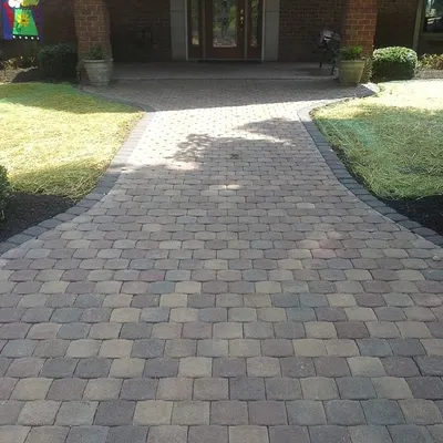 This is a finished paver walkway leading to the front door. It provides a clean, stable path and improves the curb appeal of the home. The new sod on either side will grow in to complete the look.