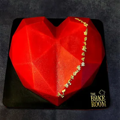 This geometric heart piñata cake is a modern and exciting way to celebrate your love. It has a hard chocolate shell that you can break open to reveal a surprise of cakes, chocolates, or other treats inside.