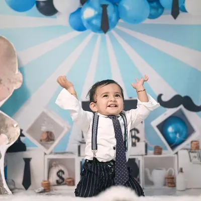 For this Boss Baby themed shoot, I created a custom backdrop with blue and white stripes and fun props like money bags and a giant character cutout to bring the theme to life.