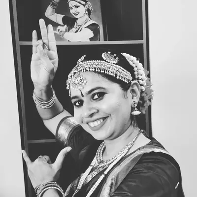 A portrait in my full Bharatnatyam attire, with a sketch of another performance in the background. For me, Krishna and dance are inseparable, creating a world full of life and happiness.