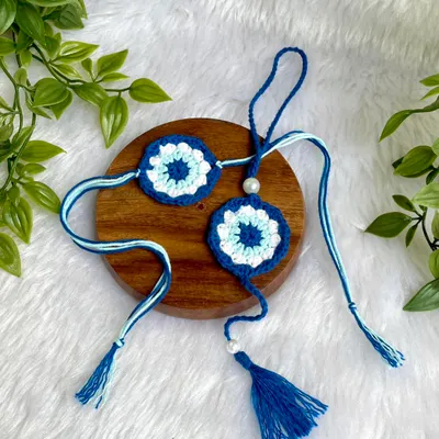 This is a custom Evil Eye Rakhi and Lumba set I made. The evil eye design is meant to offer protection, making it a thoughtful and meaningful gift for Rakshabandhan.
