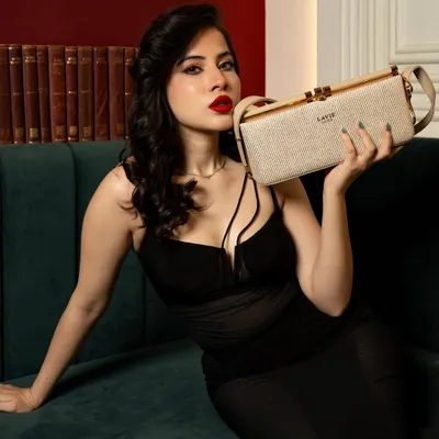 A shot from the 'Occasion Edit' campaign for Lavie, featuring Uorfi Javed. The focus is on creating a luxurious and celebratory mood, with the handbag as a key element of the story.
